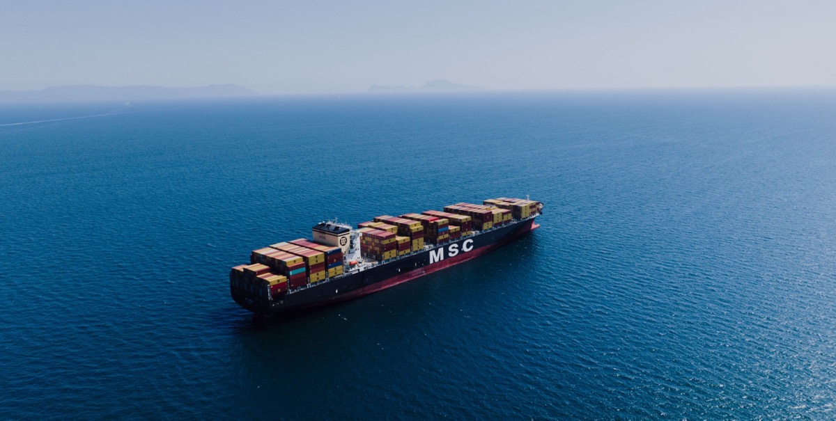 Container ship loaded with containers under way in open water
