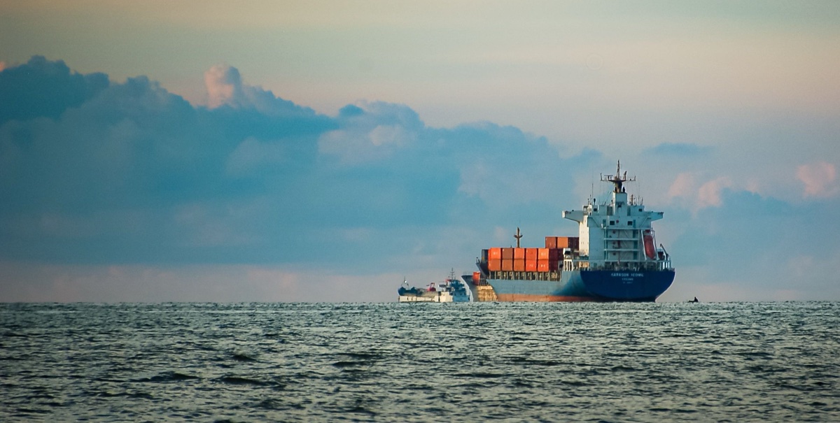 Container ship waiting at sea at dusk